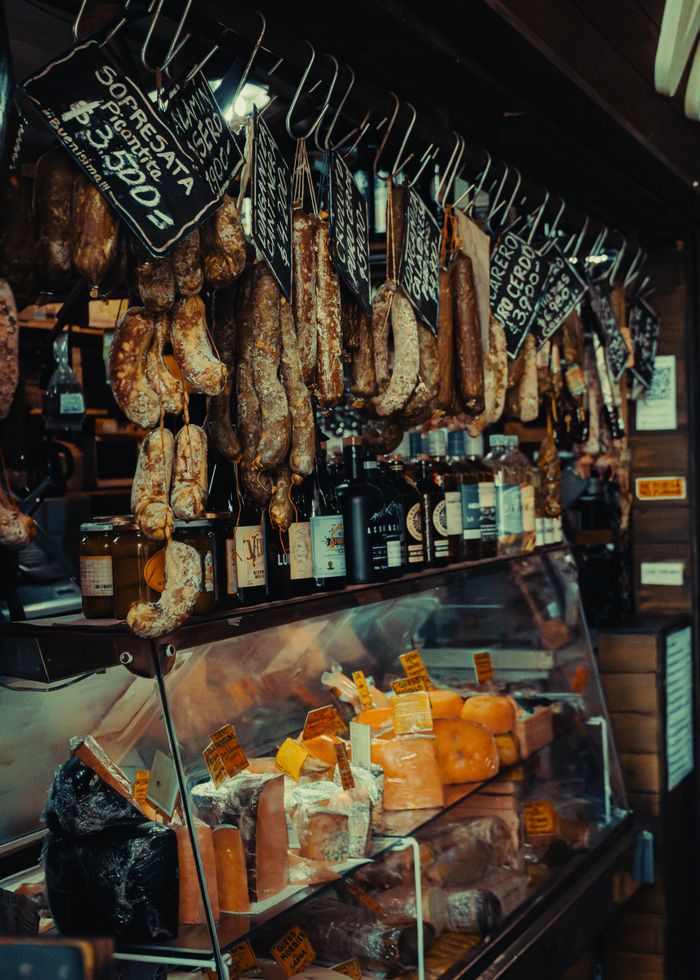 services-01 Assorted sausages and cheeses on display at a traditional Buenos Aires food market.